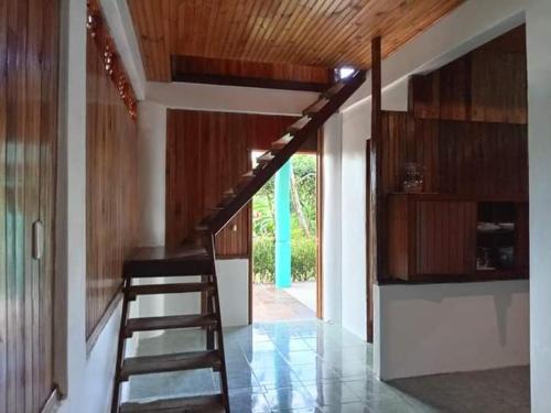 a staircase in a house with a wooden ceiling at Casa Miramar in Uvita