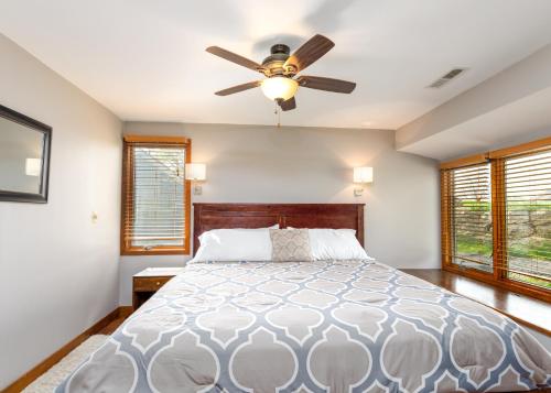 a bedroom with a bed with a ceiling fan at Quiet Home Minutes from Lake Galena & Eagle Ridge in Galena