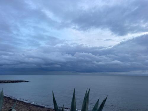 a view of the ocean on a cloudy day at Bistrot del mare in Santo Stefano al Mare