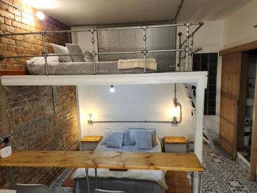 a room with a bunk bed and a table at Samor centro histórico Bogota in Bogotá