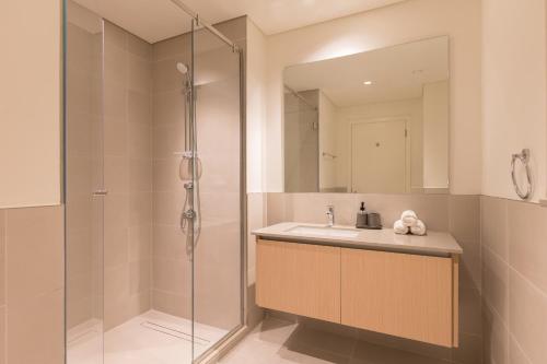a bathroom with a sink and a shower at Creek Beach Roomy 3BR + terrace in Dubai