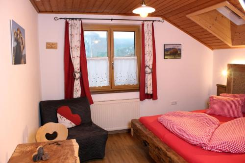 a bedroom with a bed and a window at Familienbauernhof Christa in Rossleithen