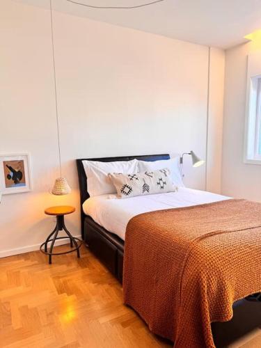 a bedroom with a large bed and a table at Porto Aldoar Boutique Flat Garden -Duarte in Porto