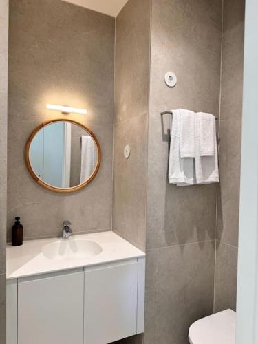 a bathroom with a sink and a mirror at Porto Aldoar Boutique Flat Garden -Duarte in Porto
