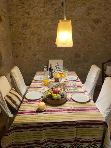a table with a bowl of fruit on it at Arachova5634 in Arachova