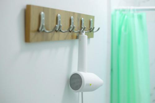 a bathroom with a shower with a speaker on the wall at Hotel 33 in Almaty