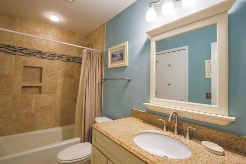 a bathroom with a sink and a toilet and a shower at Parkside~ in Kiawah Island
