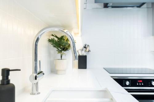 a kitchen counter with a sink and a faucet at Granby Gem: Exquisite 3-Bed Flat in Harrogate