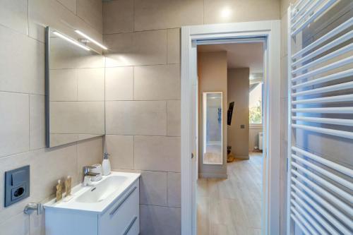 a white bathroom with a sink and a mirror at Cris by Totiaran in Baqueira-Beret