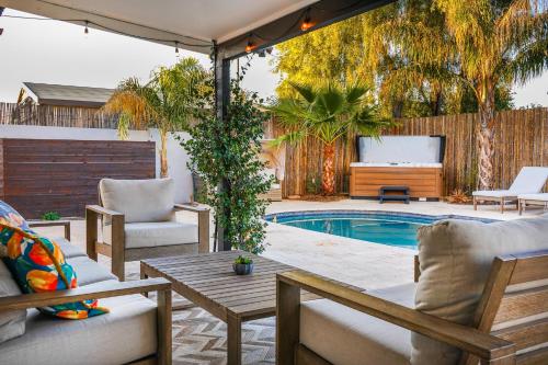 a patio with a pool and chairs and a table at Citrus Grove in Mesa
