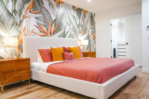 a bedroom with a large bed with colorful pillows at Citrus Grove in Mesa