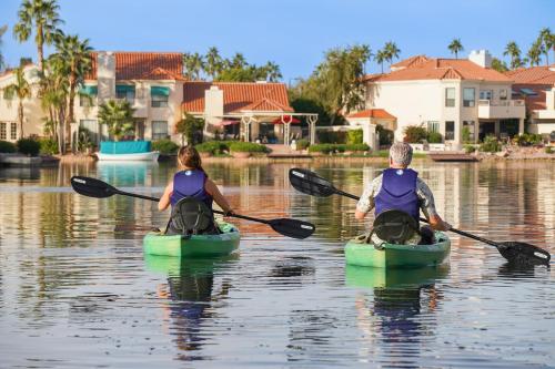 two people in kayaks on a body of water at Lakeside Luxury Val Vista in Gilbert