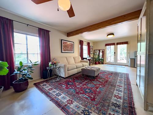 a living room with a couch and a rug at The Guest Dahl House of Sedona in Sedona