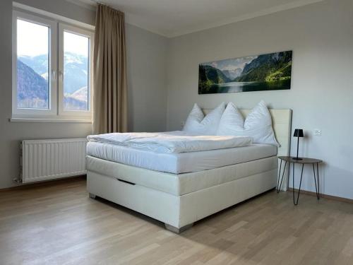 a bedroom with a white bed with a large window at Haus Altenmarkt in Möllbrücke