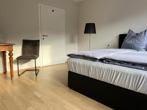 a bedroom with a bed and a desk and a chair at Haus Altenmarkt in Möllbrücke