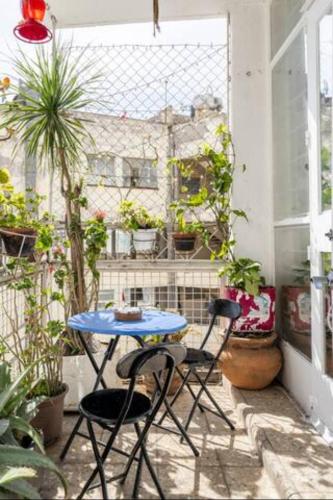 a patio with a table and two chairs and plants at Casa Itzae B&B Polanquito Dog Friendly in Mexico City