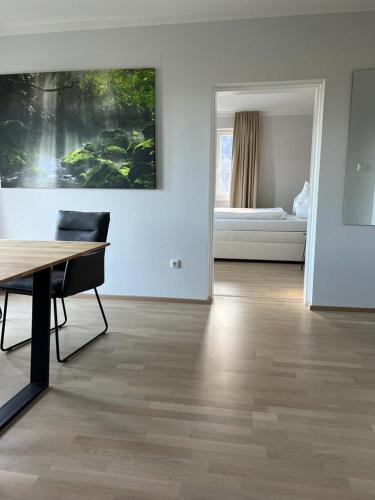 a living room with a table and a painting on the wall at Haus Altenmarkt in Möllbrücke