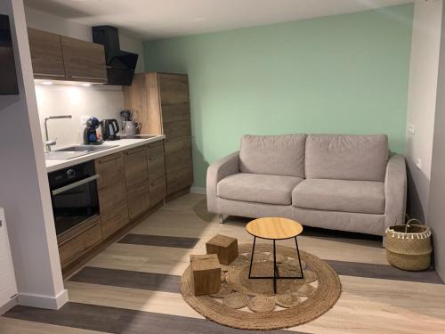 un salon avec un canapé et une table dans l'établissement L'étape de Marcel - Zanini, à Avoine