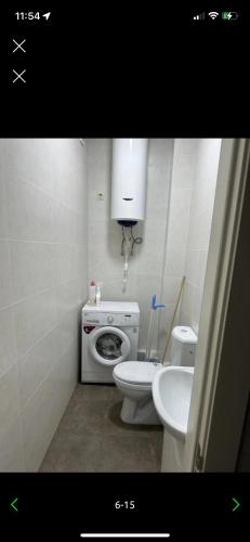 a small bathroom with a toilet and a sink at Apartment Bishkek Kok-Dzhar district in Këk-Dzhar