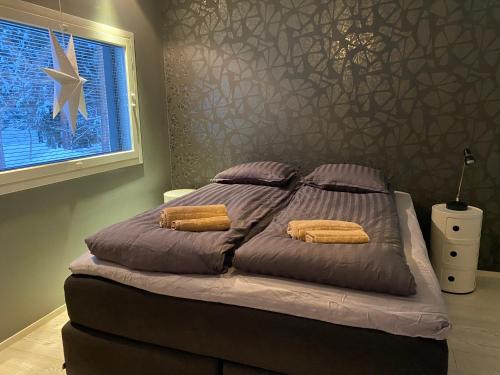 un letto con due cuscini sopra in una camera da letto di Villa Harmony a Rovaniemi
