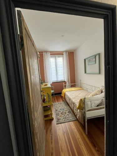a small bedroom with a bed and a window at LINO'S HOUSE in Sori