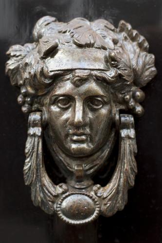 a bronze statue of a face on a door at Zocher6 a monumental town house in the city center in Utrecht