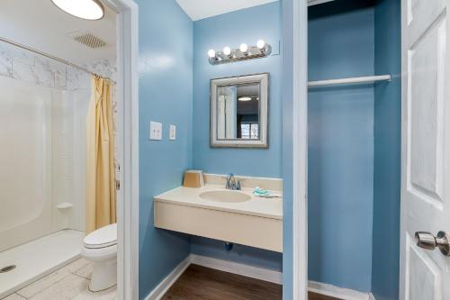 a blue bathroom with a sink and a toilet at The Starwood Inn in Bohemia