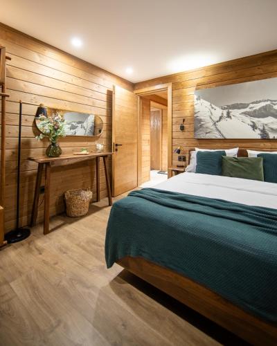 a bedroom with a large bed and a desk at La Râu 663A - Riverside Mountain Chalet with Outdoor Jacuzzi in Porumbacu de Sus