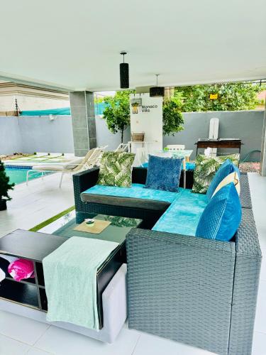 a patio with wicker furniture and a pool at Monaco villa Gaborone in Gaborone