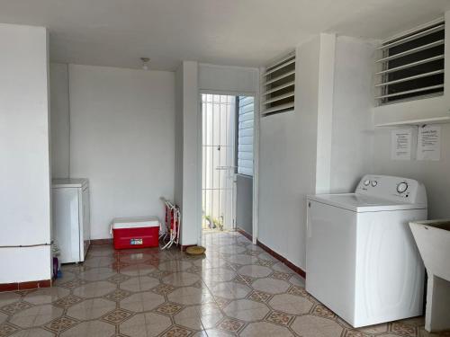 a kitchen with a washer and dryer in a room at Beautiful Caribbean Waters - 7 Seas Beach, El Yunque, Icacos Island in Fajardo