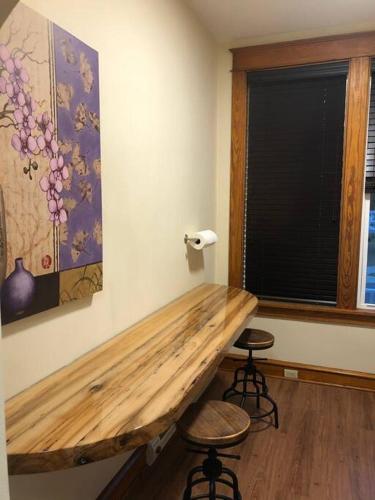 a room with a wooden table and two stools at Small Town Hideaway in Wyalusing