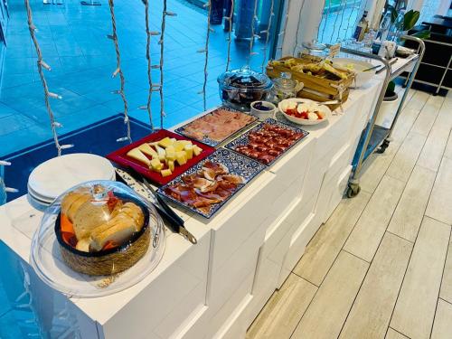 a buffet with many different types of food on a table at Blue Shades Hotel in Pisa