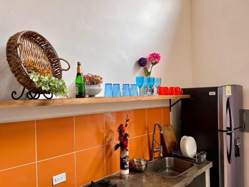 a kitchen with a counter with a sink and a refrigerator at Lemon House 2 in Las Palmeras