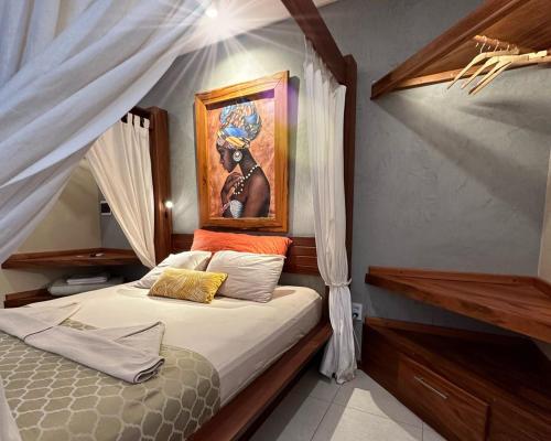 a bedroom with a bed with a painting on the wall at Pousada Oasis Paracuru in Paracuru