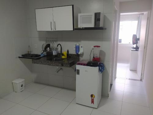 a kitchen with a small white refrigerator in a room at AP Completo em Garanhuns vista avenida (104) in Garanhuns