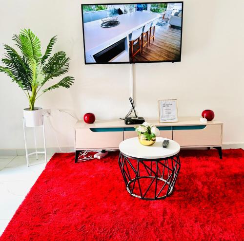 una sala de estar con una alfombra roja y una mesa en Monaco villa Palapye en Palapye