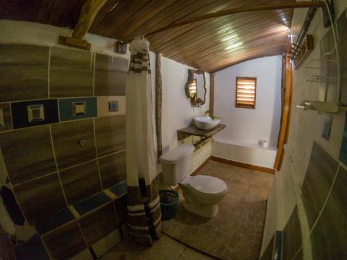 a bathroom with a toilet and a sink at Cayuco Maya in Bacalar