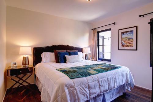 a bedroom with a large bed and a window at West Beach Villa 4 in Santa Barbara
