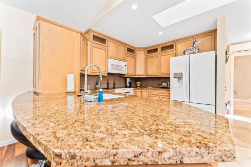 a kitchen with a marble counter top and a refrigerator at Alpine Chalet in Leavenworth