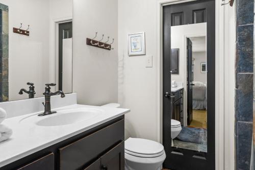 a bathroom with a white sink and a toilet at Rockin' 7 in Glen Rose
