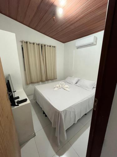 Ένα ή περισσότερα κρεβάτια σε δωμάτιο στο PARAISO DAS ÁGUAS - CHALÉ