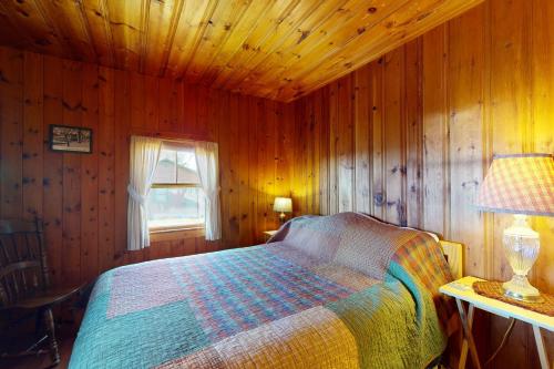 a bedroom with a bed in a wooden cabin at Castine Cottages #6 in Castine