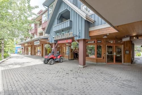 a red motorcycle parked in front of a building at Town Plaza 427 in Whistler