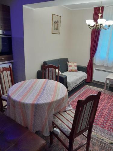 a living room with a table and a couch at WEGA Star Apartmani in Brzeće