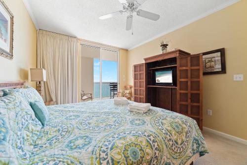 a bedroom with a bed and a flat screen tv at Beach Club Avalon 1204 in Gulf Highlands