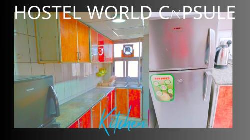 a kitchen with a refrigerator in the middle of it at UAE Capsule Hostel 5 min Walkable from Sharaf DG Metro in Dubai