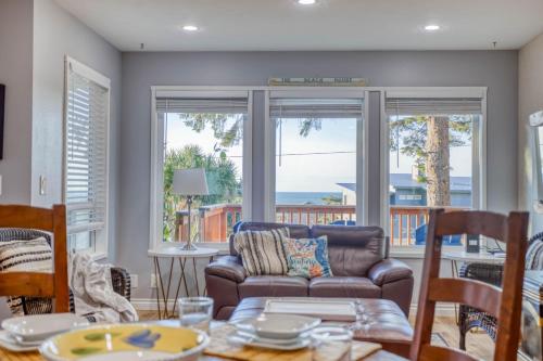 a living room with a couch and a view of the ocean at Just Beachy 101 in Yachats