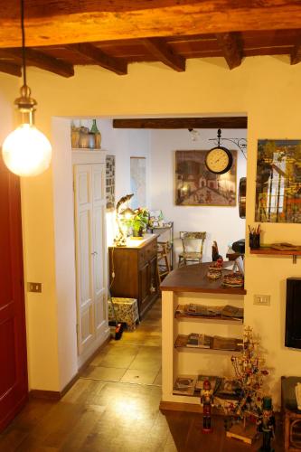 a room with a kitchen and a dining room with a table at I Rosai appartamento sulle colline fiorentine in Bagno a Ripoli