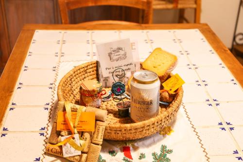 a picnic basket with food and a drink on a table at I Rosai appartamento sulle colline fiorentine in Bagno a Ripoli