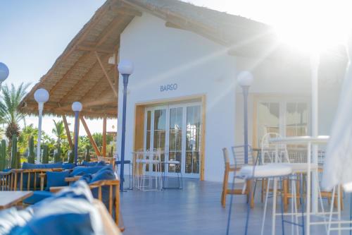 a patio with chairs and tables and a building at Hotel Indigo La Paz Puerta Cortes, an IHG Hotel in La Paz